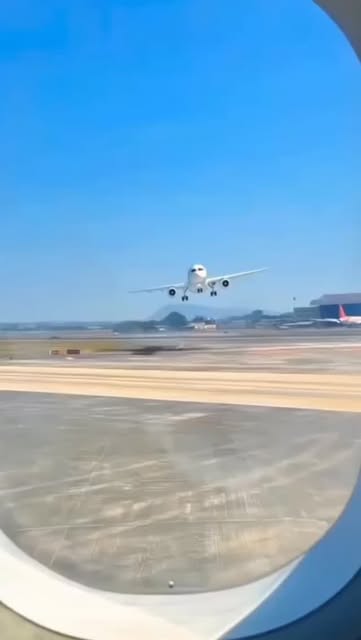 A plane landing seen through an aircraft window in Jamaica