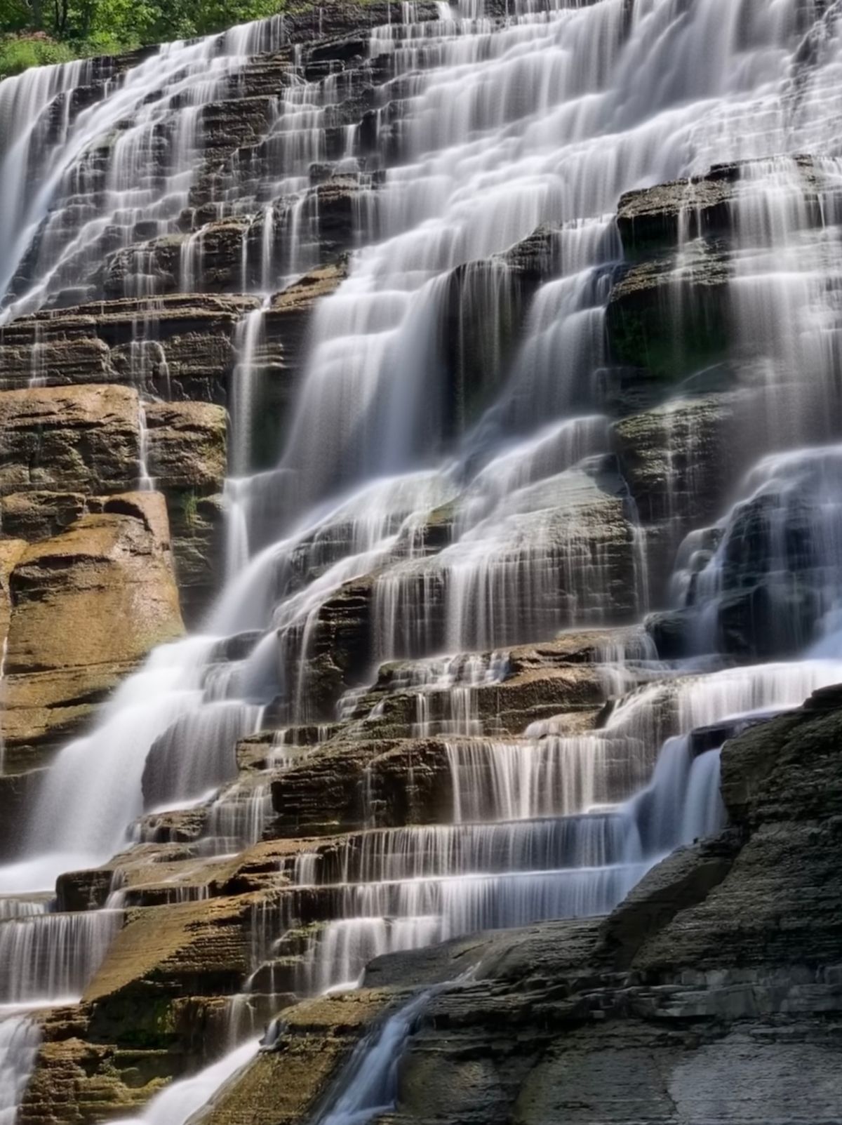 Wide terraced falls stepping down through the rocks
